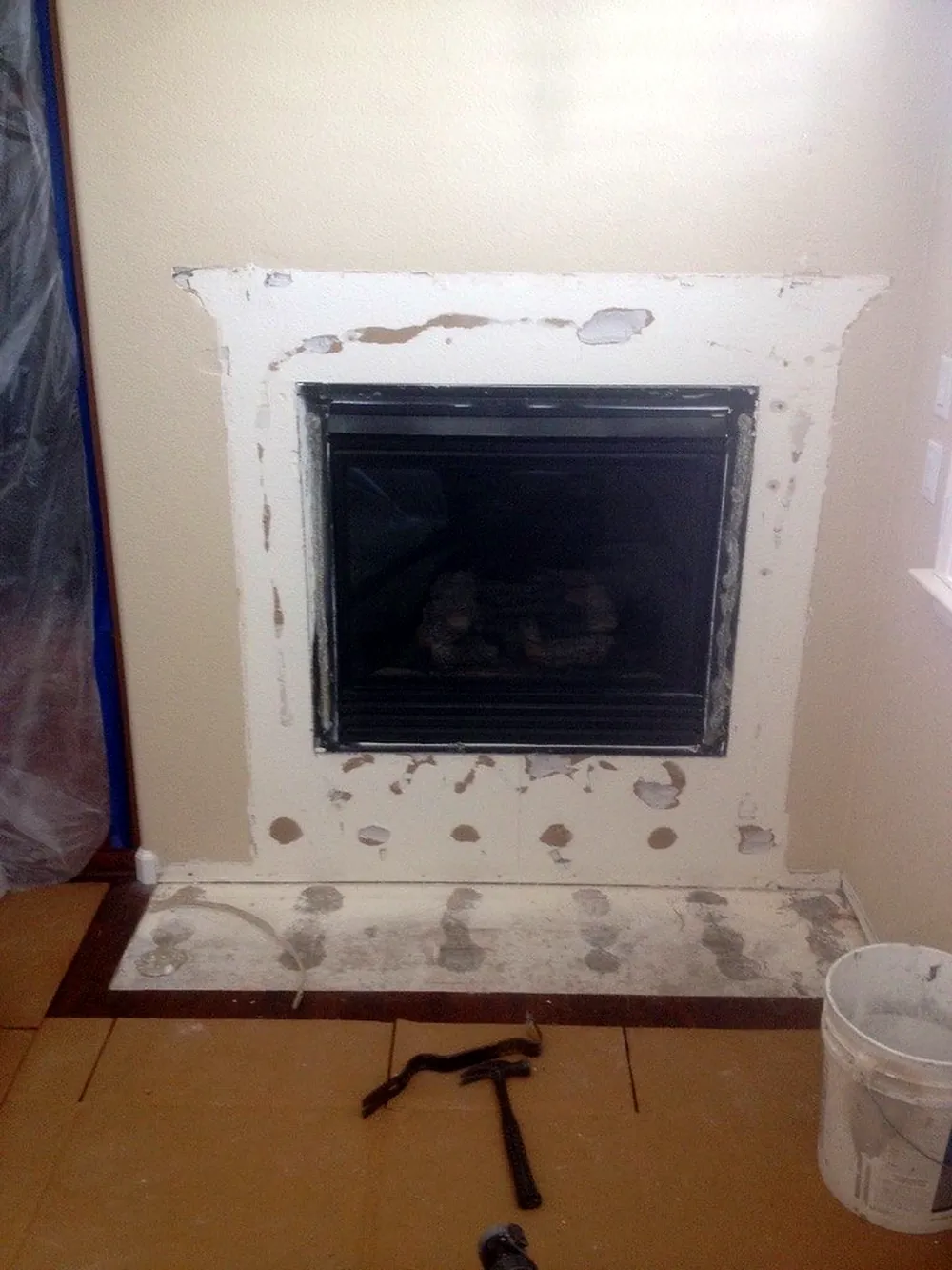 Before: fireplace surround stripped and patched, ready for stone