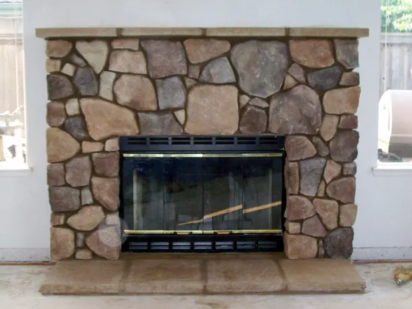 Stone veneer fireplace by Nick Lambdin Masonry
