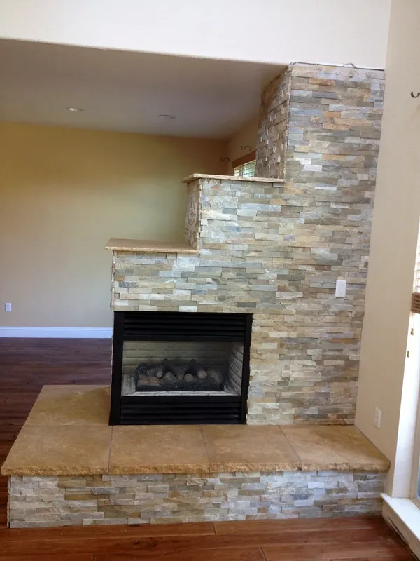 See-through ledgestone fireplace by Nick Lambdin Masonry