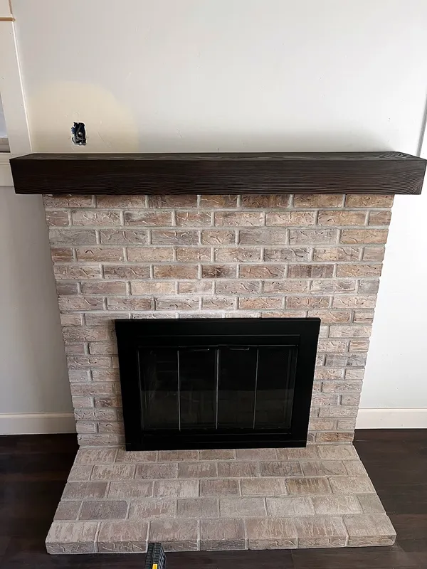 Whitewashed brick fireplace by Nick Lambdin Masonry