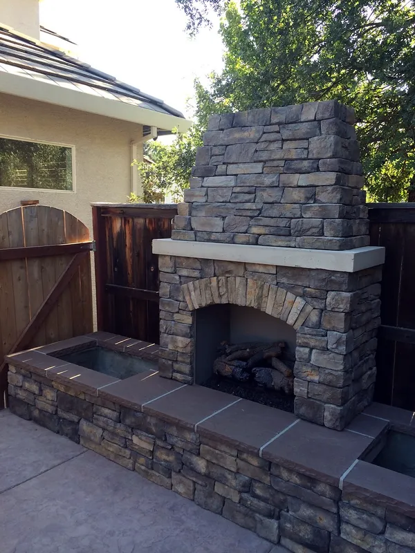 Outdoor stone fireplace by Nick Lambdin Masonry